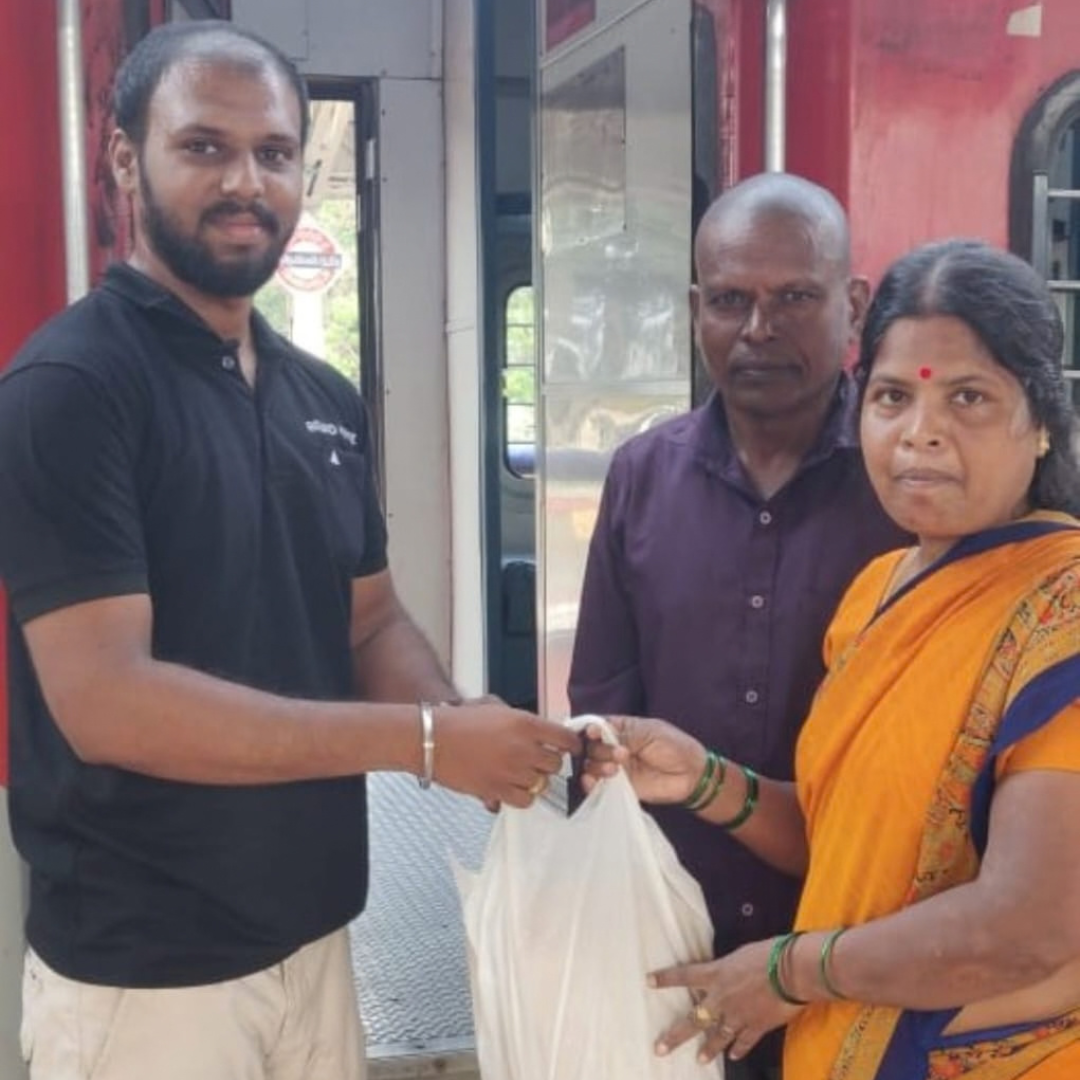 Nellai Specialz team handing a sweet order to customers